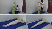 A girl is wrapped in a prayer position and given a stimulus with a vibrator